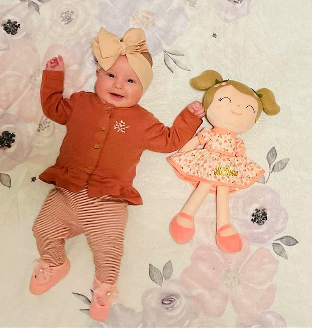 Mckenna Love is registered to the contest to win money with this photo: art, baby, baby_products, baby_toddler_clothing, child, costume_hat, fun, gesture, happy, hat, headwear, illustration, pattern, peach, person, pink, product, sleeve, textile, toddler