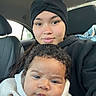 Jamari joined the competition — help win amazing prizes! baby, child, woman, car, headwrap, hoodie, seat, window, portrait, face, curly_hair, casual_clothing, indoor, person, seated, looking_at_camera, young, toddler, cozy, family