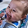 baby, child, chocolate, closeup, clothing, cookie, cute, face, food, hand, happy, highchair, indoor, infant, joyful, messy, mouth, portrait, smiling, young