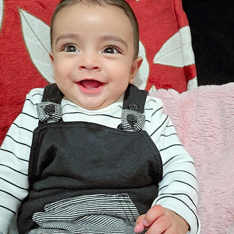 Hartaj Singh joined the competition — help win amazing prizes! applique, baby, bodypart, clothing, couch, cushion, face, finger, furniture, hand, happy, head, homedecor, pants, pattern, person, photography, portrait, sitting, smile