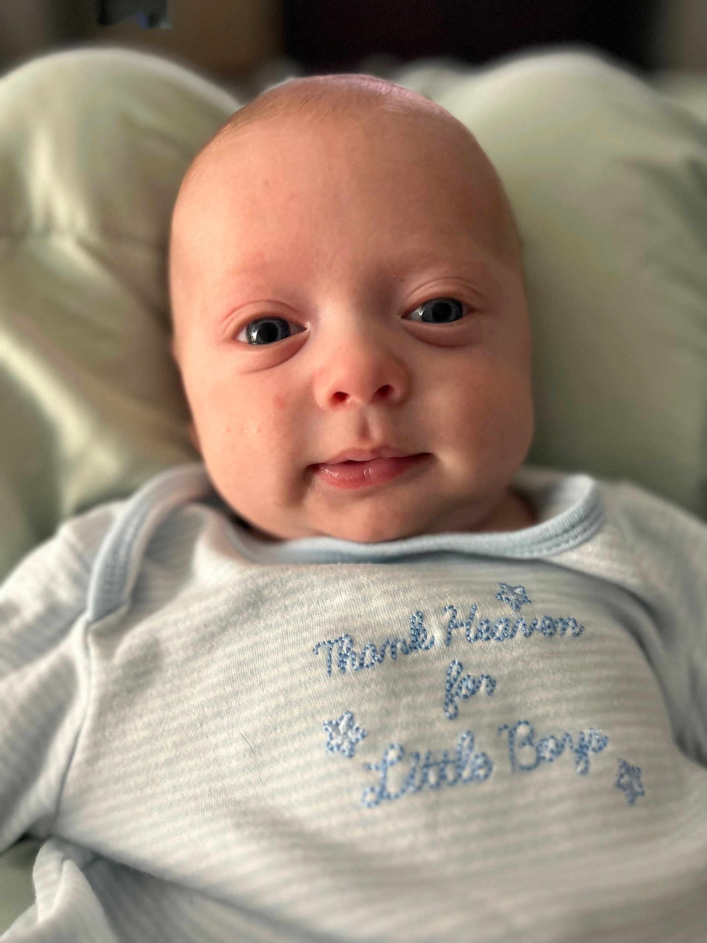 Brantley joined the competition — help win amazing prizes! baby, infant, face, eyes, smile, clothing, blue, portrait, closeup, cute, child, newborn, soft_light, expression, resting, young, human, skin, head, apparel