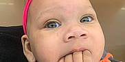 Oaklynn joined the competition — help win amazing prizes! apparel, baby, chewing, child, closeup, clothing, curious, cute, face, fingers_in_mouth, gray, headband, indoor, infant, orange, person, portrait, shopping, snack_shelves, young_child
