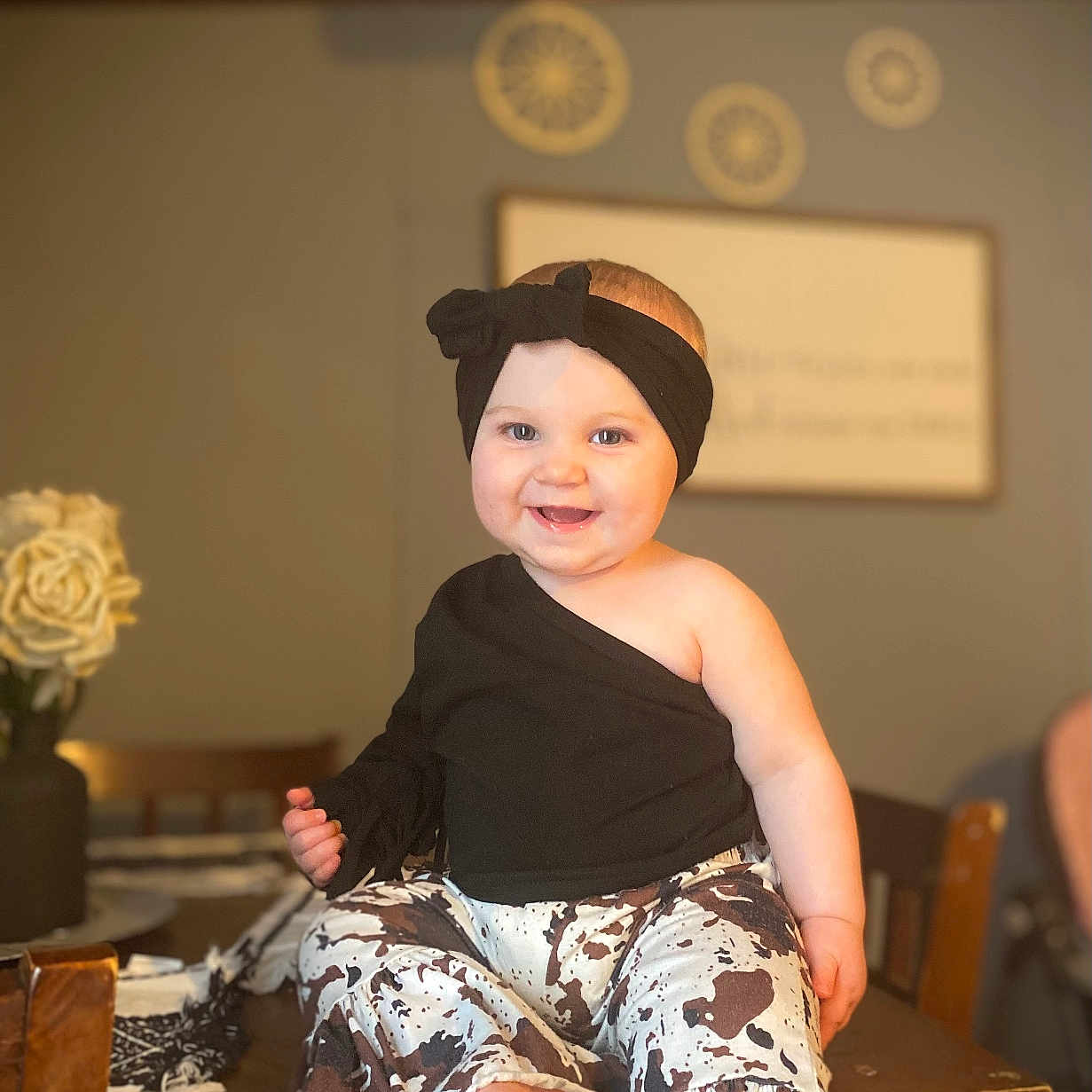 Oaklynn joined the competition — help win amazing prizes! baby, clothing, diningtable, dress, face, footwear, furniture, happy, head, pants, person, photography, plant, portrait, pottedplant, shoe, sitting, smile, table, wood