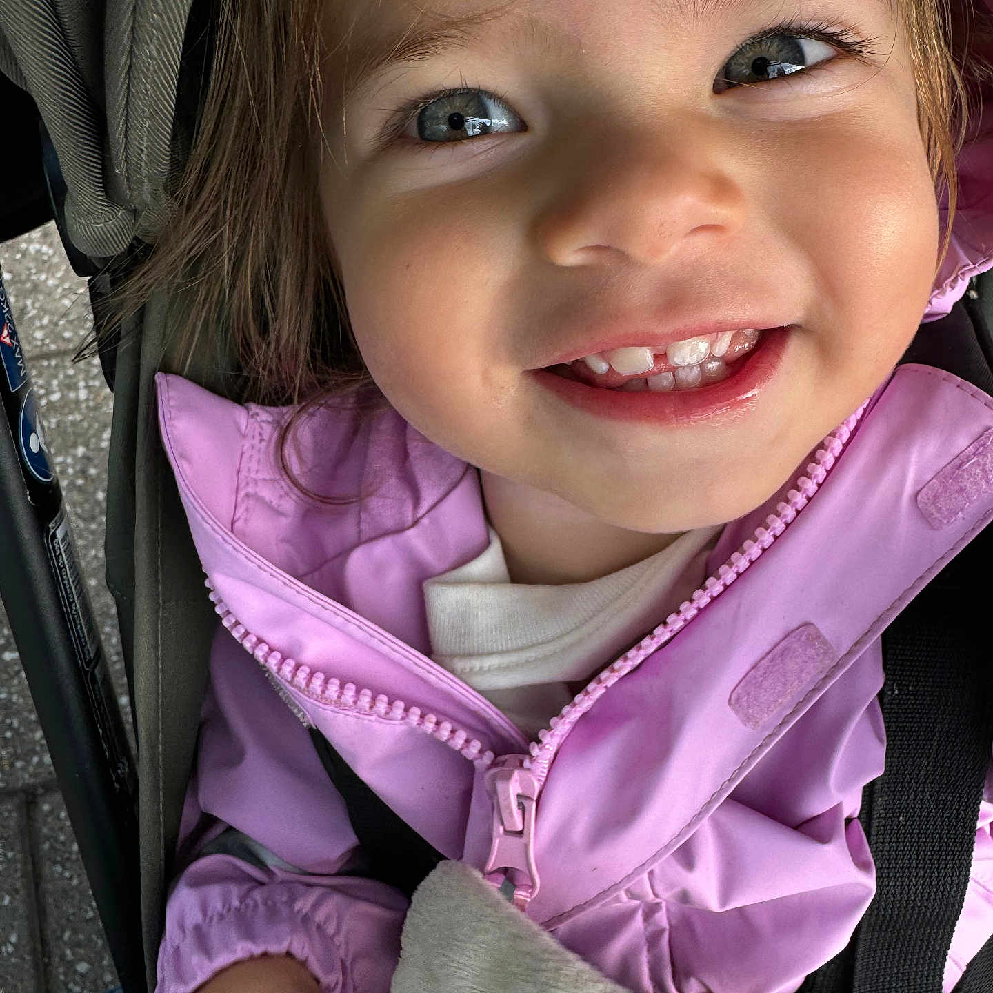 Penelope joined the competition — help win amazing prizes! baby, bodypart, clothing, coat, face, happy, hat, head, hood, hoodie, jacket, mouth, pants, person, photography, portrait, purple, smile, stroller, teeth