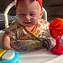 Adaline joined the competition — help win amazing prizes! baby, child, headband, red_bow, walker, toy, smiling, indoor, clothing, person, face, happy, furniture, couch, blanket, colorful, playtime, infant, cute, home