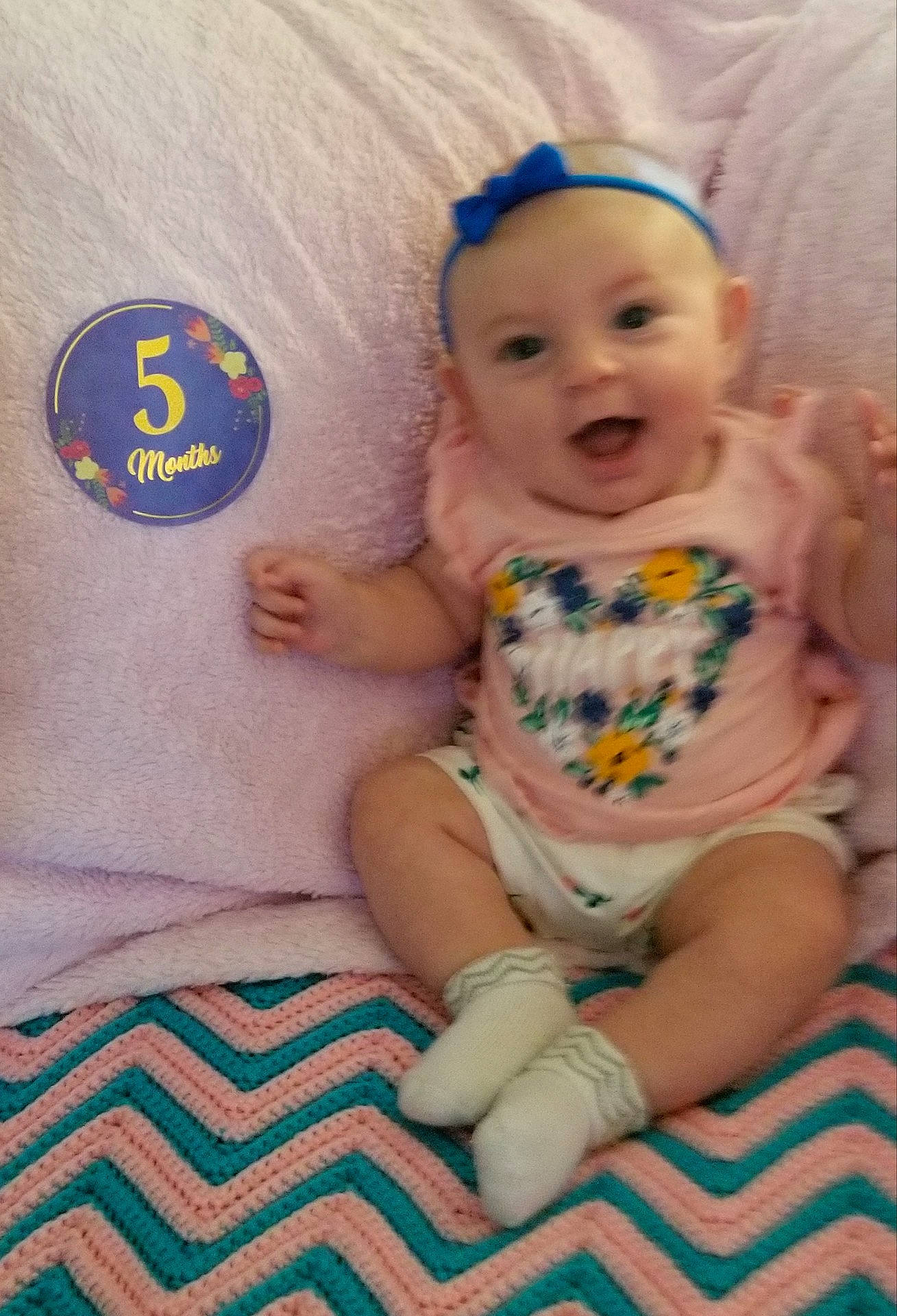 Tayla is registered to the contest to win money with this photo: baby_products, bedtime, blue, cheek, child, day, eye, finger, hair_accessory, head, headgear, human_hair_color, infant, iris, person, play, product, skin, smile, textile