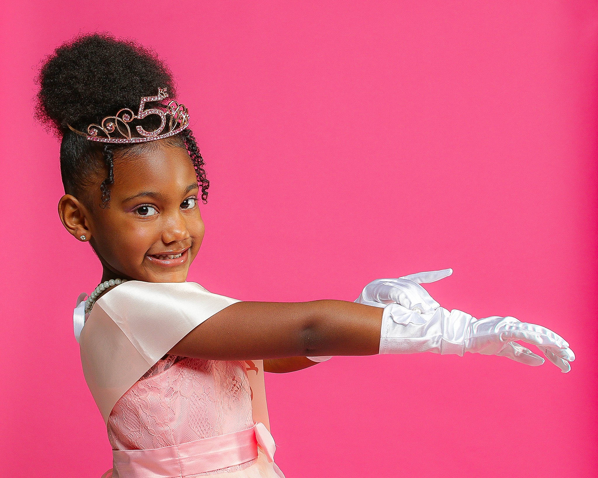 Kamille is registered to the contest to win money with this photo: child, dance, dancer, event, fashion_accessory, gesture, glove, hair_accessory, hairstyle, headband, headpiece, joy, majorette_dancer, performance, person, pink