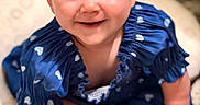 Rosealeine is registered to the contest to win money with this photo: baby, child, infant, smiling, happy, portrait, sitting, blue_dress, heart_pattern, play_mat, indoor, close_up, face, eyes, hair, hands, legs, barefoot, crawling, adorable