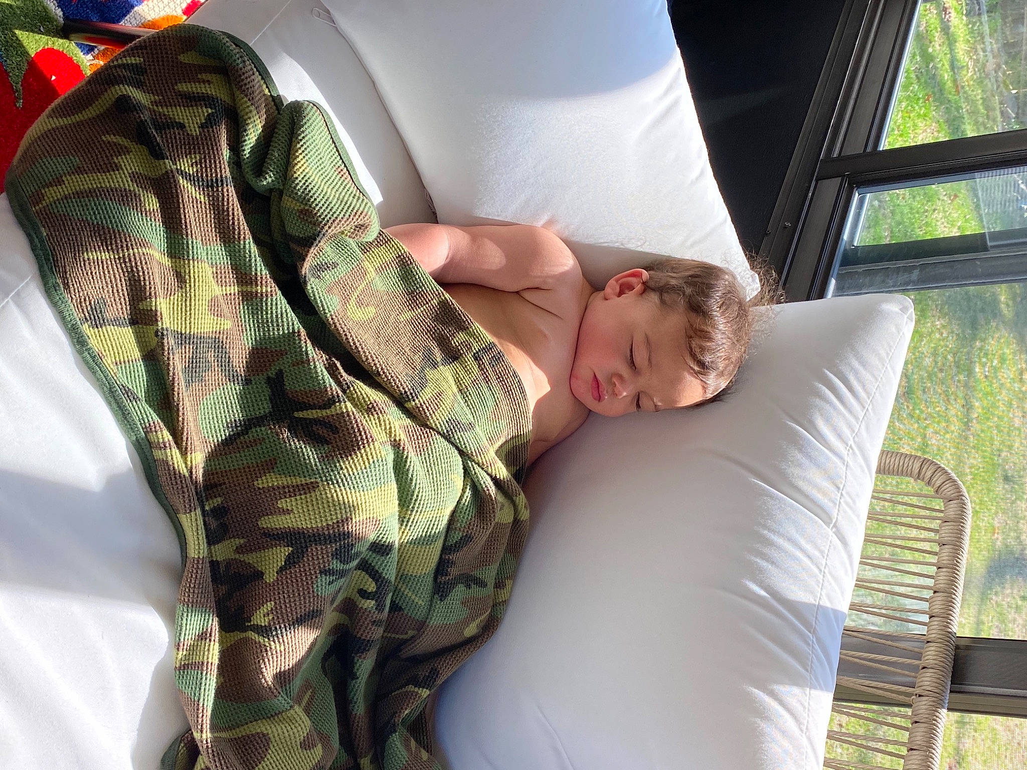 Caius is registered to the contest to win money with this photo: arm, car_seat, comfort, couch, family_car, gesture, human_leg, joint, leg, leisure, linens, military_camouflage, motor_vehicle, pattern, person, room, shoulder, sitting, t_shirt, thigh