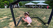 Madison is registered to the contest to win money with this photo: child, girl, soccer_goal, net, grass, outdoor, daylight, tent, people, play, happy, dress, bow, sport, event, recreation, summer, fun, smile, field