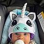 Elias is registered to the contest to win money with this photo: baby, unicorn_hat, bottle, car_seat, blue_eyes, striped_clothing, infant, cute, child, feeding, headwear, soft_toy_style, seat_padding, indoor, portrait, baby_face, childcare, adorable, young_child, comfort