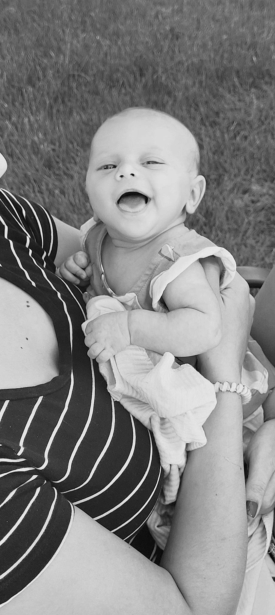 Ellie is registered to the contest to win money with this photo: baby, baby_toddler_clothing, black, black_and_white, finger, flash_photography, gesture, grass, hand, happy, human, organ, people, people_in_nature, person, photograph, sleeve, smile, style, toddler