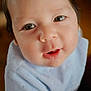 Ethan is registered to the contest to win money with this photo: baby, child, face, eyes, mouth, blue_clothing, curious, soft_lighting, portrait, indoor, close_up, infant, cute, young_child, expression, skin, hair, person, looking_up, wearing