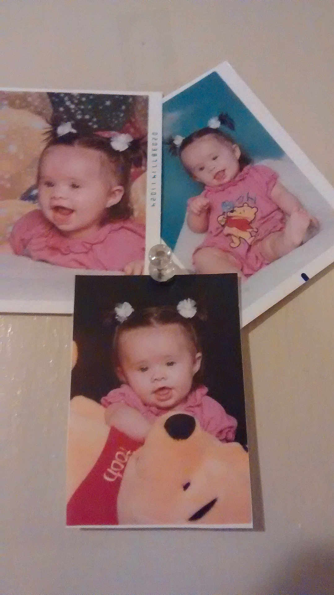 Shyanne is registered to the contest to win money with this photo: baby, child, photograph, pigtails, pink_clothing, plush_toy, winnie_the_pooh, smile, portrait, wall, pin, hair_accessory, indoor, cute, infant, expression, person, multiple_photos, collage, background