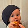 Ange a rejoint le concours — aidez-le/la à gagner de superbes lots ! baby, child, face, blue_eyes, cap, black_cap, croissant, pastry, food, hand, helping_hand, holding, eating, indoor, portrait, cute, close_up, soft_light, cozy, person