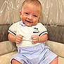 baby, child, smiling, sitting, clothing, white_polo, shorts, face, happy, cute, indoor, chair, furniture, skin, portrait, young_child, hands, legs, head, baby_boy