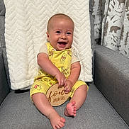 Caleb joined the competition — help win amazing prizes! baby, smiling, sitting, yellow_clothing, winnie_the_pooh, woodland_curtains, gray_armchair, soft_blanket, happy, infant, indoors, cute, child, plush_texture, wooden_sign, four_months, portrait, feet, hands, cozy