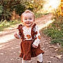 autumn, brown, child, clothing, cute, daylight, dress, forest, happy, leaves, nature, outdoor, path, person, smiling, sunlight, toddler, walking, white_tights, young_child