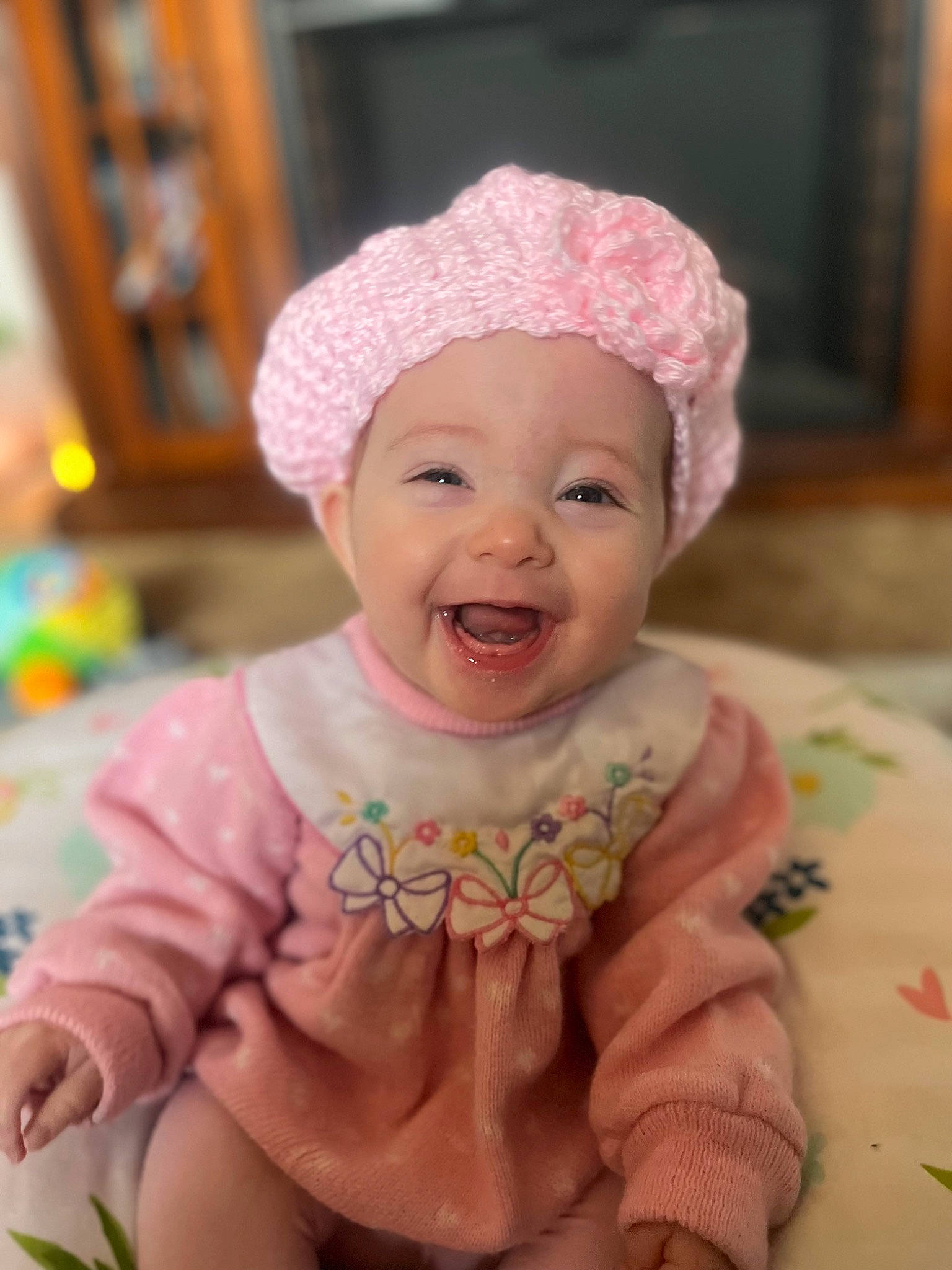 Quinley is registered to the contest to win money with this photo: baby, baby_laughing, baby_toddler_clothing, cap, cheek, clothing, eye, face, fashion_accessory, fun, happy, head, headwear, magenta, outerwear, person, pink, purple, skin, sleeve