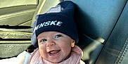 Tatum joined the competition — help win amazing prizes! baby, beanie, bib, blanket, car_seat, child, clothing, floral, happy, hat, infant, interior, leather, navy_blue, pink, portrait, seatbelt, smiling, sunlight, window