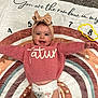 baby, blanket, carpet, child, clothing, cute, diaper, happy, headband, headwear, indoor, infant, numbers, person, pink_sweater, playful, portrait, rainbow, smiling, toddler