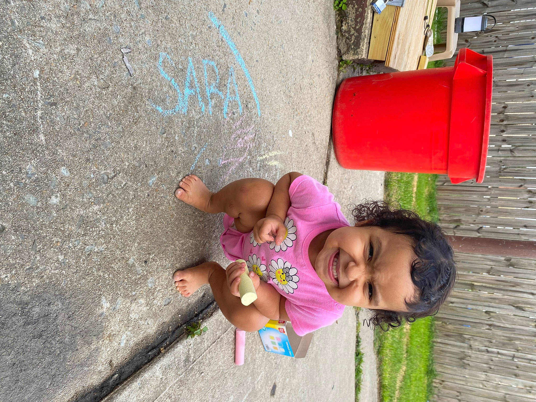 Sara is registered to the contest to win money with this photo: asphalt, beauty, child, city, fun, grass, green, handwriting, happy, joy, leisure, person, pink, public_space, road_surface, smile, snapshot, summer, toddler, tree