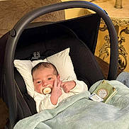 Mohmed Iyed participe au concours pour gagner de l'argent avec cette photo : baby, baby_carrier, blanket, clothing, comfort, couch, cute, face, furniture, hand, indoor, infant, newborn, pacifier, person, pillow, resting, soft, table, warm