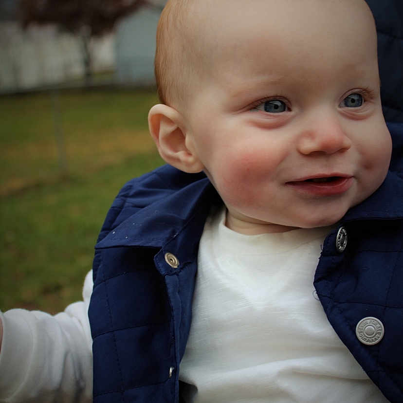Brady is registered to the contest to win money with this photo: baby, cheek, child, chin, ear, eye, face, facial_expression, forehead, grass, head, lip, male, nose, person, photography, portrait, portrait_photography, skin, smile