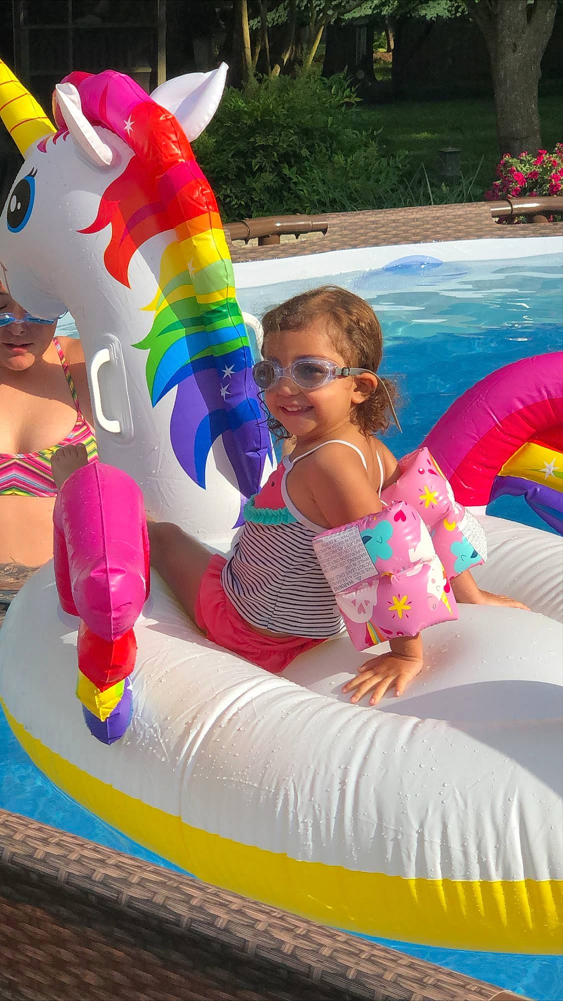 Ava is registered to the contest to win money with this photo: amusement_park, child, event, fun, games, happy, inflatable, joy, leisure, mascot, nonbuilding_structure, person, pink, plant, play, recreation, smile, swimming_pool, toddler, toy