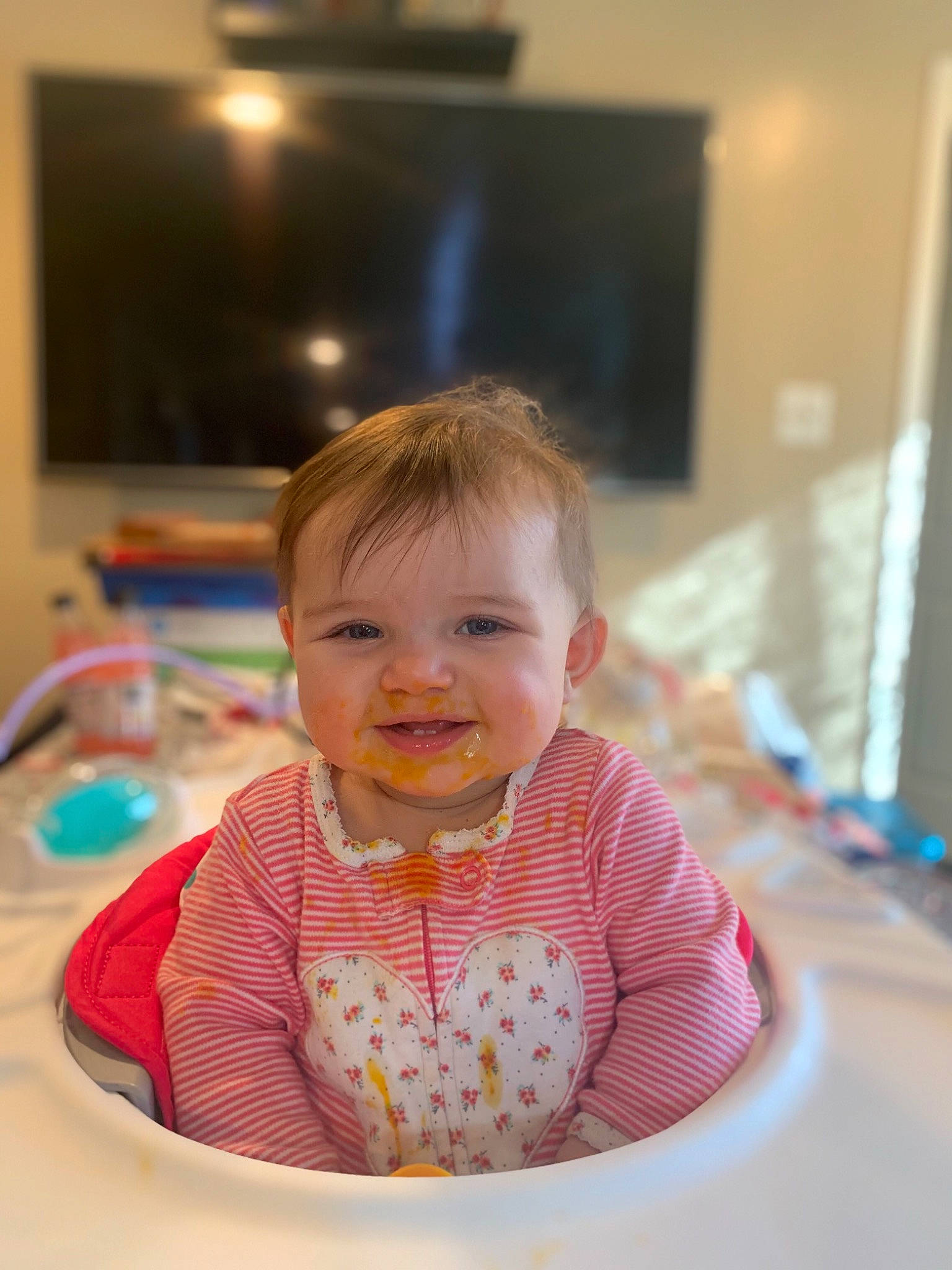 Ari joined the competition — help win amazing prizes! baby, baby_toddler_clothing, cable_television, cheek, child, facial_expression, flooring, fun, happy, iris, joy, lighting, person, picture_frame, room, sitting, skin, sleeve, smile, standing