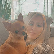 Gabbana is registered to the contest to win money with this photo: blonde_hair, casual, casual_clothing, comfortable, companion, cozy, curtains, cute_pet, dog, home, indoor, natural_light, pet, plant, portrait, relaxed, small_dog, smiling, sofa, woman