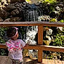 Nevaeh joined the competition — help win amazing prizes! backpack, butterfly, child, exploration, greenery, headband, nature, outdoor, pants, person, plants, rocks, serene, shadow, shoes, stream, sunlight, toddler, waterfall, wooden_deck