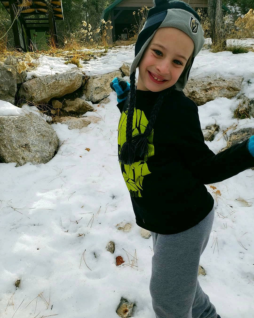 Jaxon is registered to the contest to win money with this photo: beanie, cap, child, freezing, fun, headgear, hoodie, ice, joy, leisure, outerwear, person, plant, play, playing_in_the_snow, smile, snow, toddler, tree, trousers