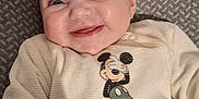 Jade participe au concours pour gagner de l'argent avec cette photo : baby, smiling, mickey_mouse, infant, clothing, blanket, cute, happy, person, portrait, child, apparel, face, baby_garment, lying_down, indoor, cozy, soft_texture, young_child, mammal