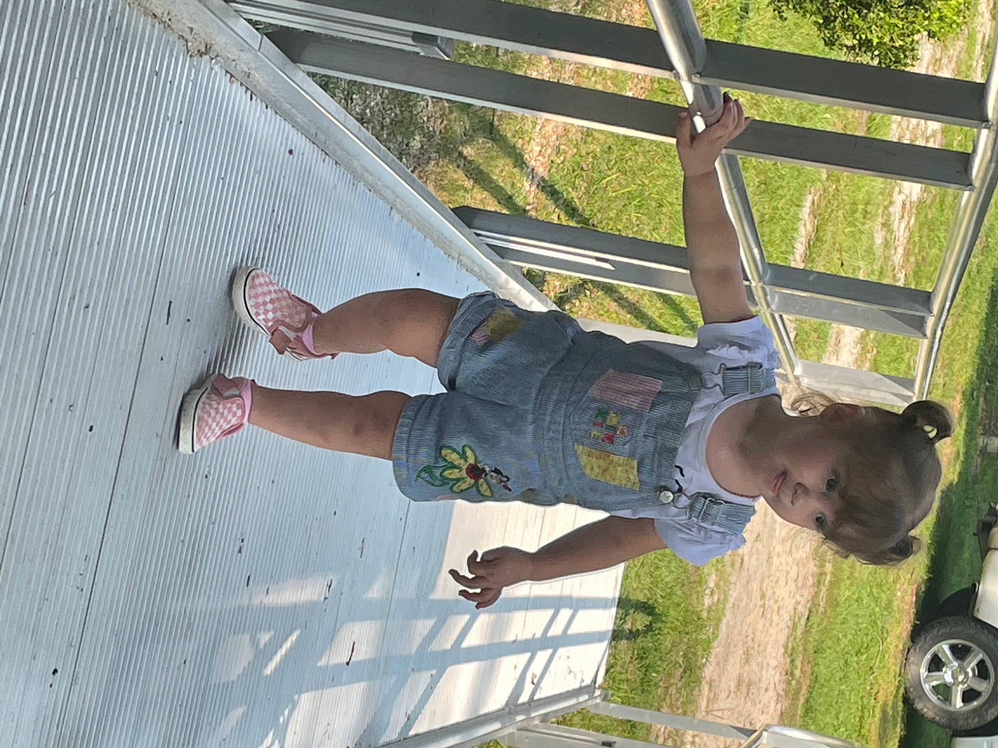 Aleaha is registered to the contest to win money with this photo: balance, child, elbow, foot, fun, grass, happy, human_leg, leisure, outdoor_play_equipment, pattern, person, play, shade, shorts, thigh, tire, toddler, vacation, walking_shoe
