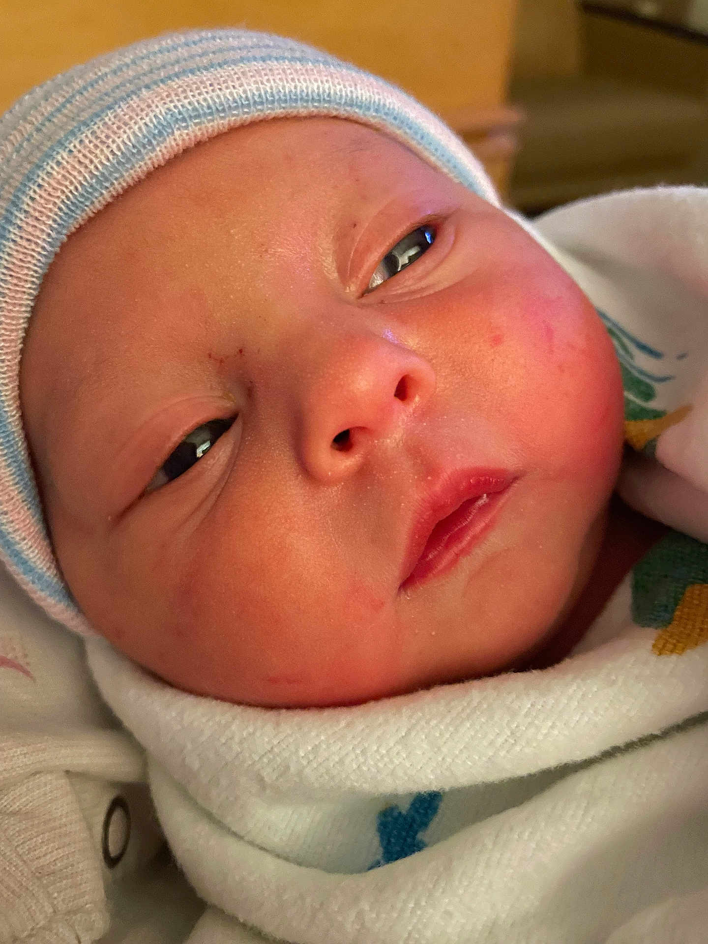 Nyxie is registered to the contest to win money with this photo: baby, beanie, blanket, bodypart, bonnet, cap, clothing, face, finger, hand, hat, head, newborn, person, photography, portrait, towel