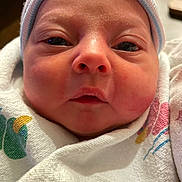 Nyxie joined the competition — help win amazing prizes! baby, beanie, blanket, bonnet, cap, clothing, face, hat, head, hood, newborn, person, photography, portrait, quilt, skin, towel
