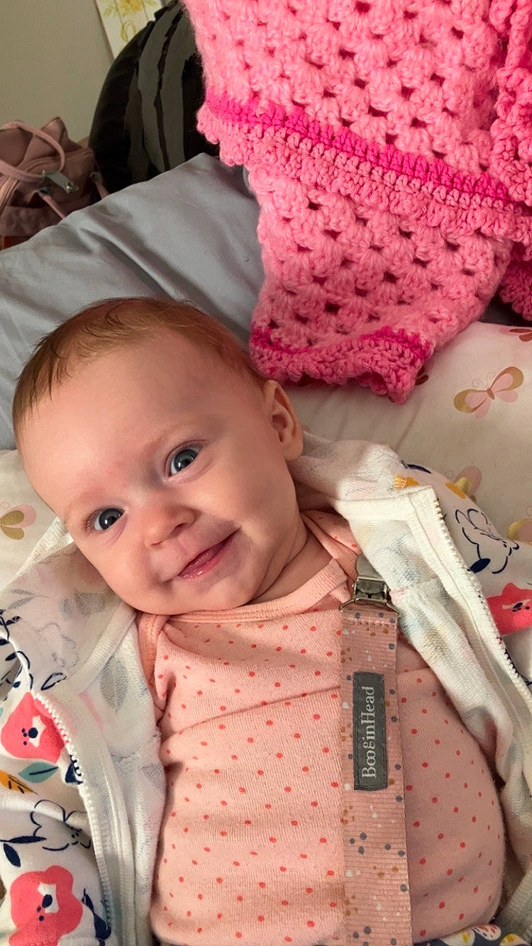 Esther is registered to the contest to win money with this photo: baby, baby_toddler_clothing, cap, cheek, creative_arts, eye, happy, head, headgear, joy, lip, organ, outerwear, people, person, pink, product, skin, smile, textile