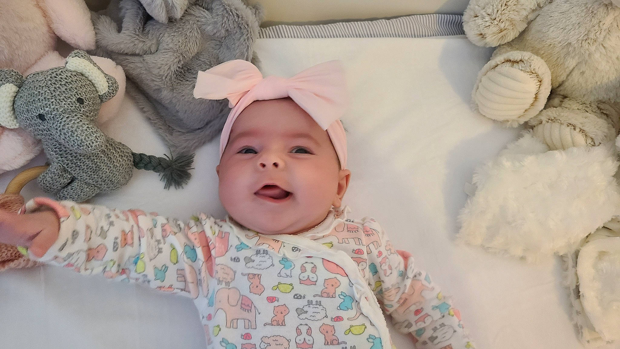 Savannah joined the competition — help win amazing prizes! baby, baby_laughing, baby_toddler_clothing, beanie, cheek, child, comfort, happy, headwear, linens, nose, pattern, person, pink, room, skin, sleeve, smile, textile, toddler