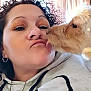 Zoey Abbie Lister is registered to the contest to win money with this photo: affection, bond, casual, closeup, curly_hair, curtains, dog, earrings, eyeshadow, face, happy, hoodie, indoor, kiss, light, makeup, pet, playful, tongue, woman