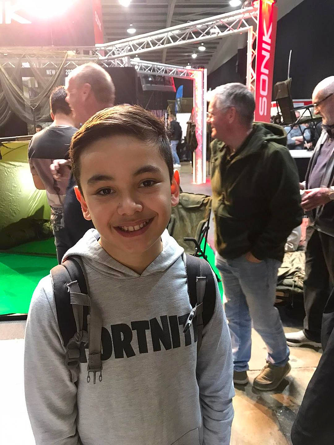 James Gilbertson is registered to the contest to win money with this photo: child, competition_event, crowd, event, eyewear, fan, fun, happy, hoodie, joy, leisure, luggage_and_bags, luxury_vehicle, motor_vehicle, person, public_event, recreation, selfie, smile, t_shirt