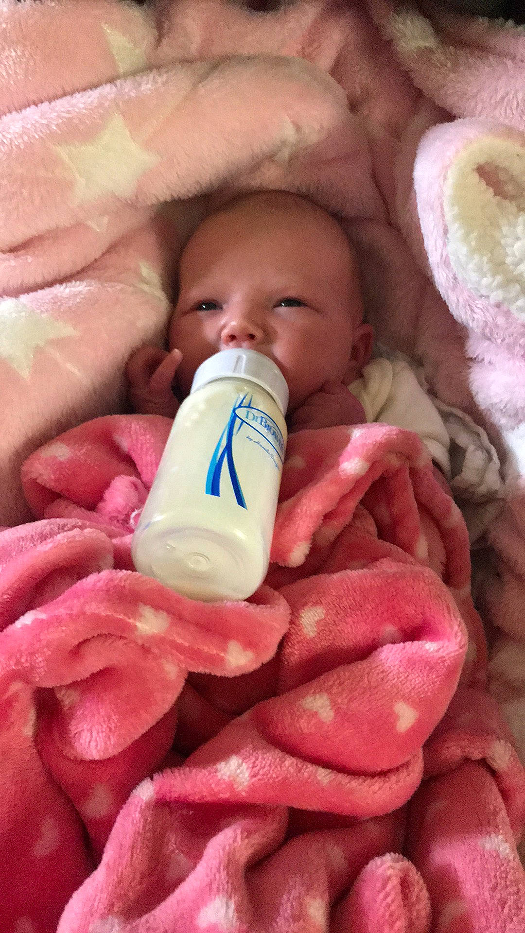 Winter joined the competition — help win amazing prizes! baby, child, close_up, comfort, drinkware, facial_expression, finger, linens, lip, mouth, nail, nail_care, nose, organ, person, pink, plastic_bottle, product, skin, textile