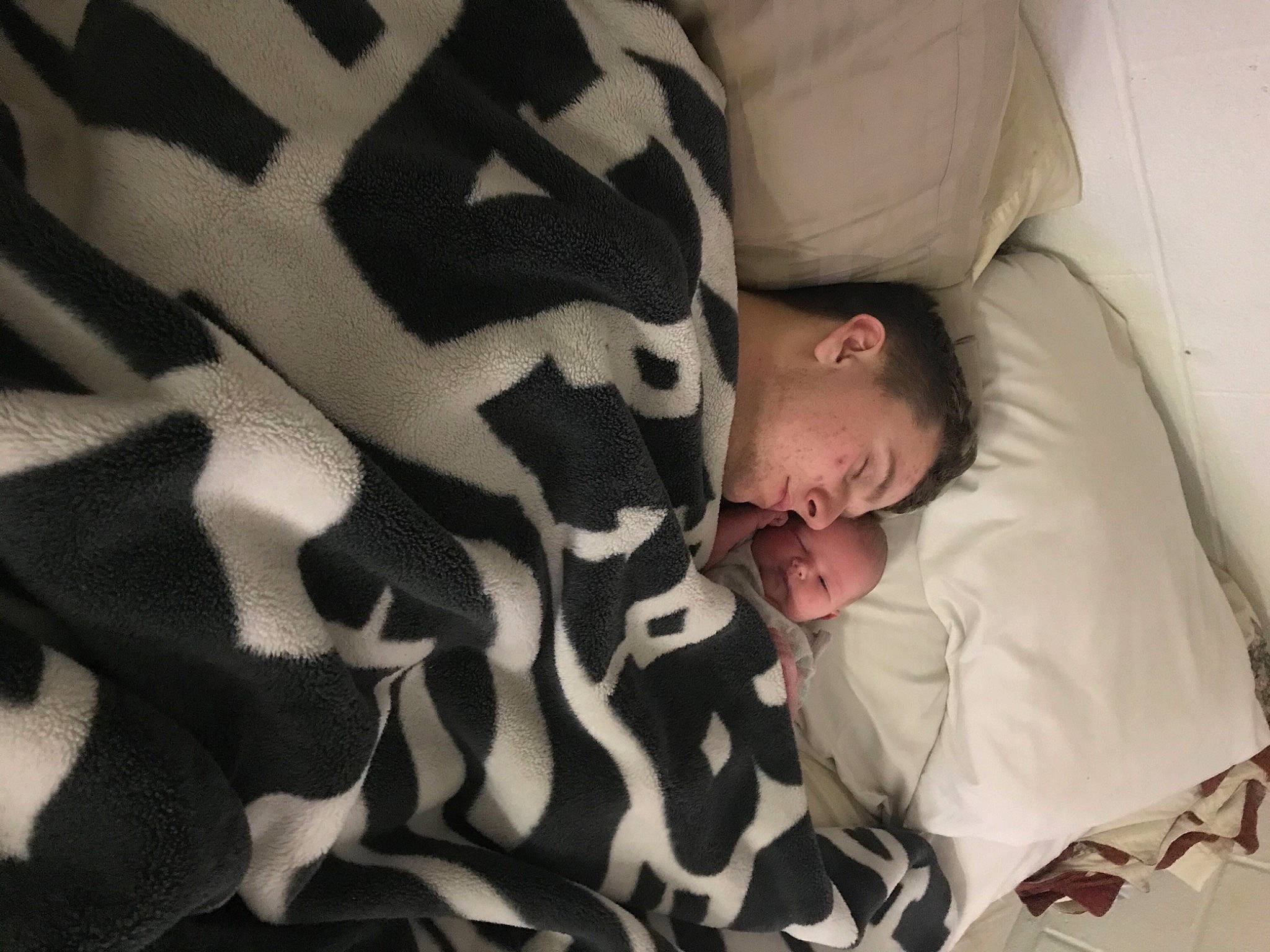 Winter is registered to the contest to win money with this photo: bed, bed_sheet, bedding, bedtime, blanket, comfort, fur, gesture, human_leg, linens, military_camouflage, nap, pattern, person, room, sleep, textile, tree
