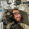 Shrimp joined the competition — help win amazing prizes! man, cat, indoor, glasses, chair, tabby_cat, facial_hair, relaxed, home, furniture, office_chair, bed, blanket, window_blinds, pet, smile, casual, comfort, person, couch