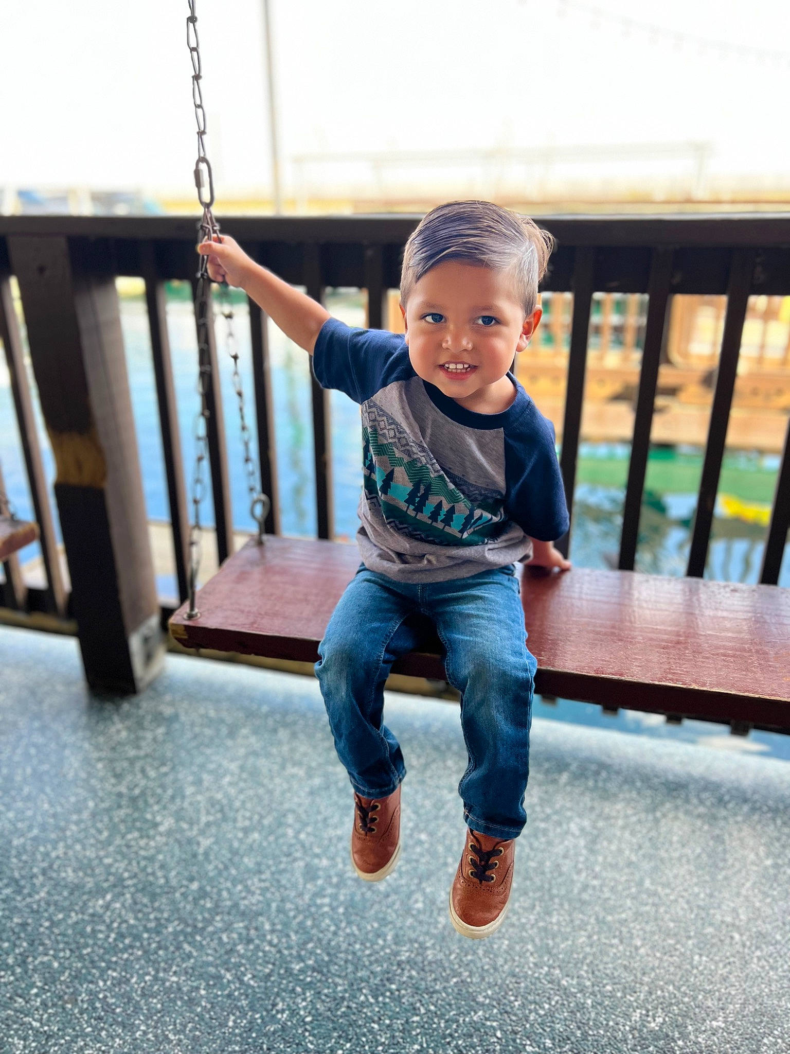 Armani is registered to the contest to win money with this photo: child, denim, electric_blue, face, fence, flooring, fun, happy, joy, leg, leisure, person, play, portrait_photography, recreation, sitting, sleeve, smile, standing, t_shirt