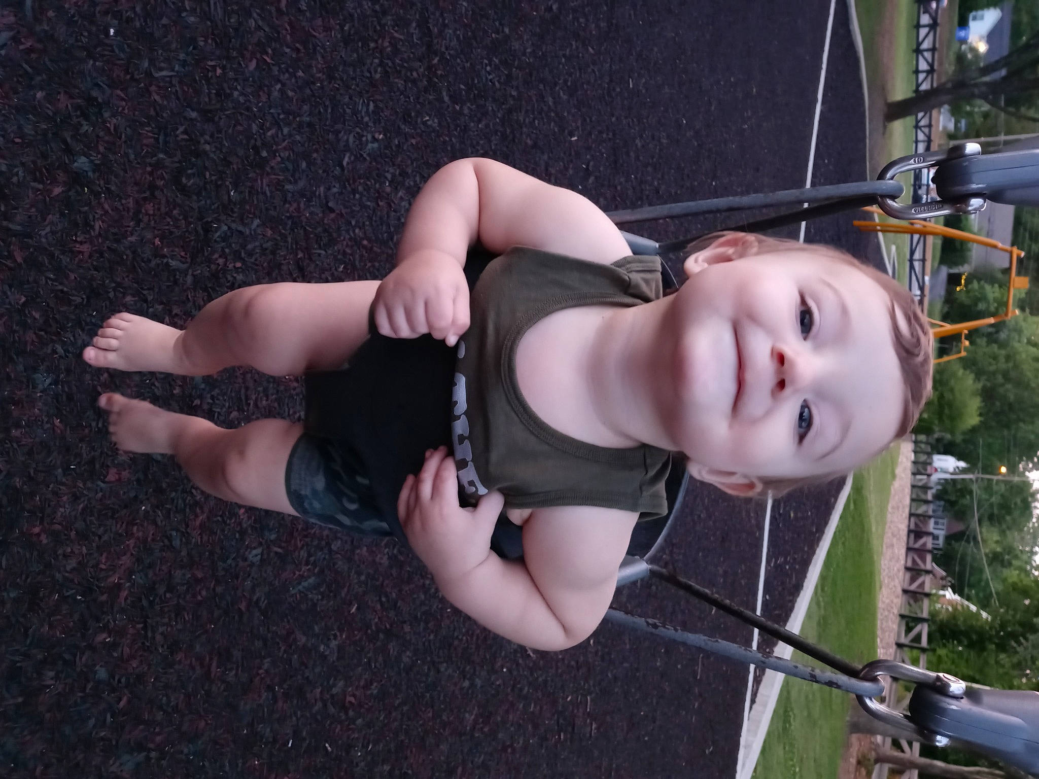 Alijah is registered to the contest to win money with this photo: automotive_exterior, automotive_wheel_system, child, flash_photography, fun, grass, human_leg, joy, knee, leg, leisure, motor_vehicle, person, plant, recreation, smile, swing, thigh, tire, tree