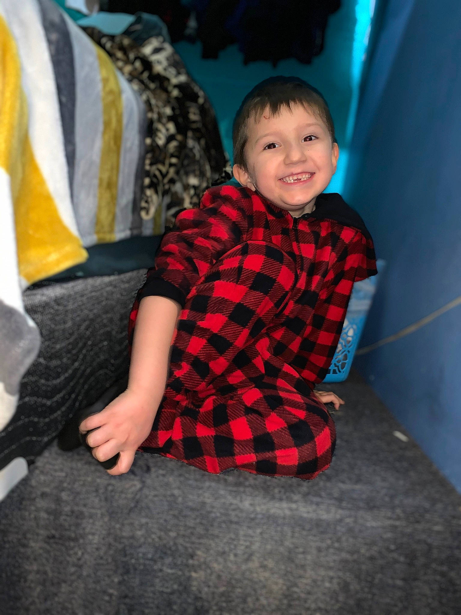 Anthony is registered to the contest to win money with this photo: child, design, fun, joy, pattern, person, plaid, sitting, skin, smile, tartan, textile, toddler, vacation