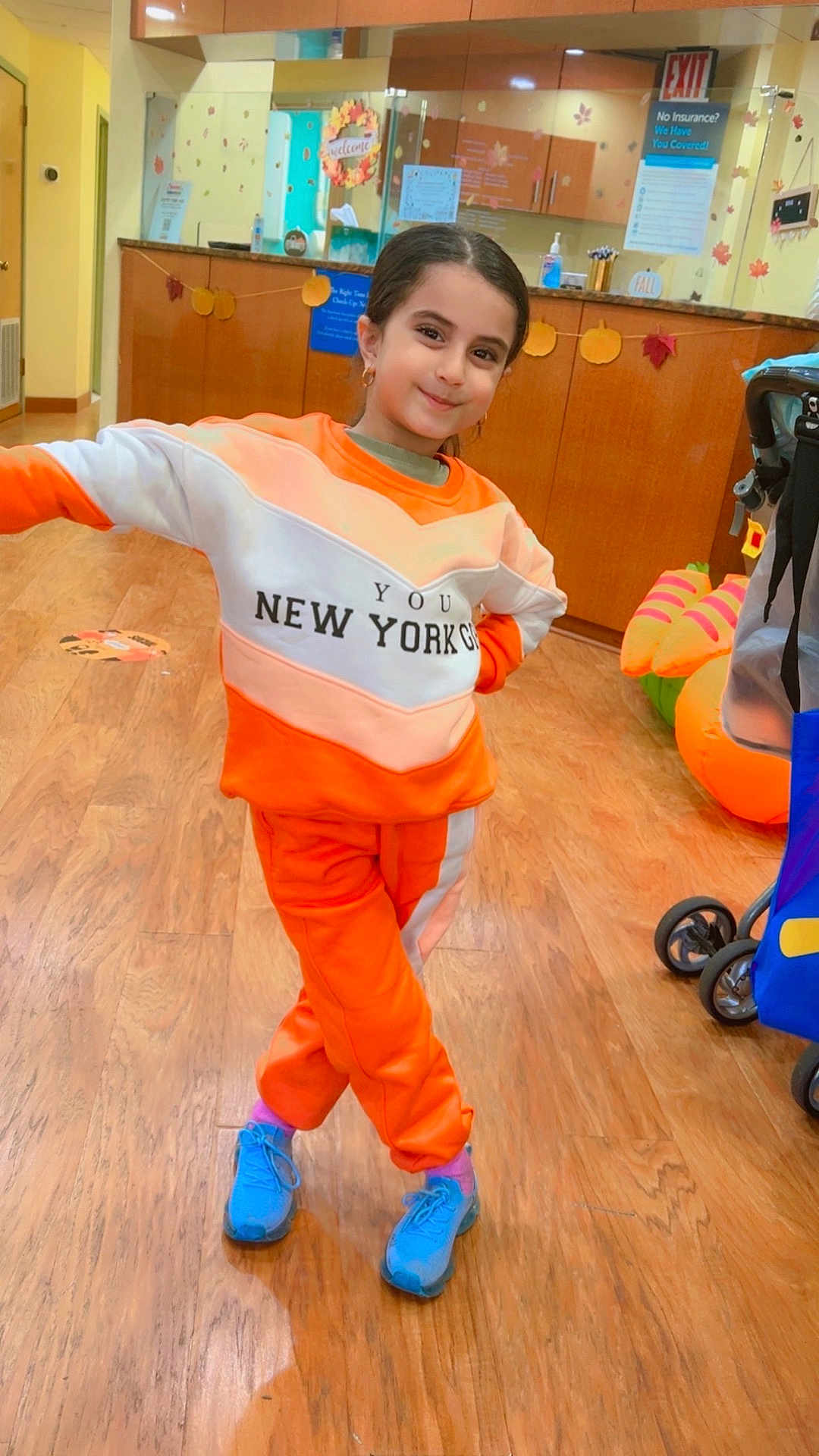 Ronza joined the competition — help win amazing prizes! blue_shoes, casual_wear, child, decorations, earrings, girl, happy, indoor, long_hair, orange_clothing, pants, person, playful, pose, pumpkin_decor, smile, stroller, sweatshirt, wood_floor, young