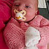Athena joined the competition — help win amazing prizes! baby, newborn, pacifier, pink_sweater, mittens, close_up, infant, cute, sleepy, cozy, soft_texture, hand_knit, resting, indoor, portrait, child, face, skin, head, person
