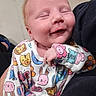 Athena is registered to the contest to win money with this photo: baby, infant, smile, sleeping, onesie, animal_print, cute, cozy, child, hand, face, person, soft_lighting, close_up, newborn, apparel, pattern, adorable, comfort, toddler